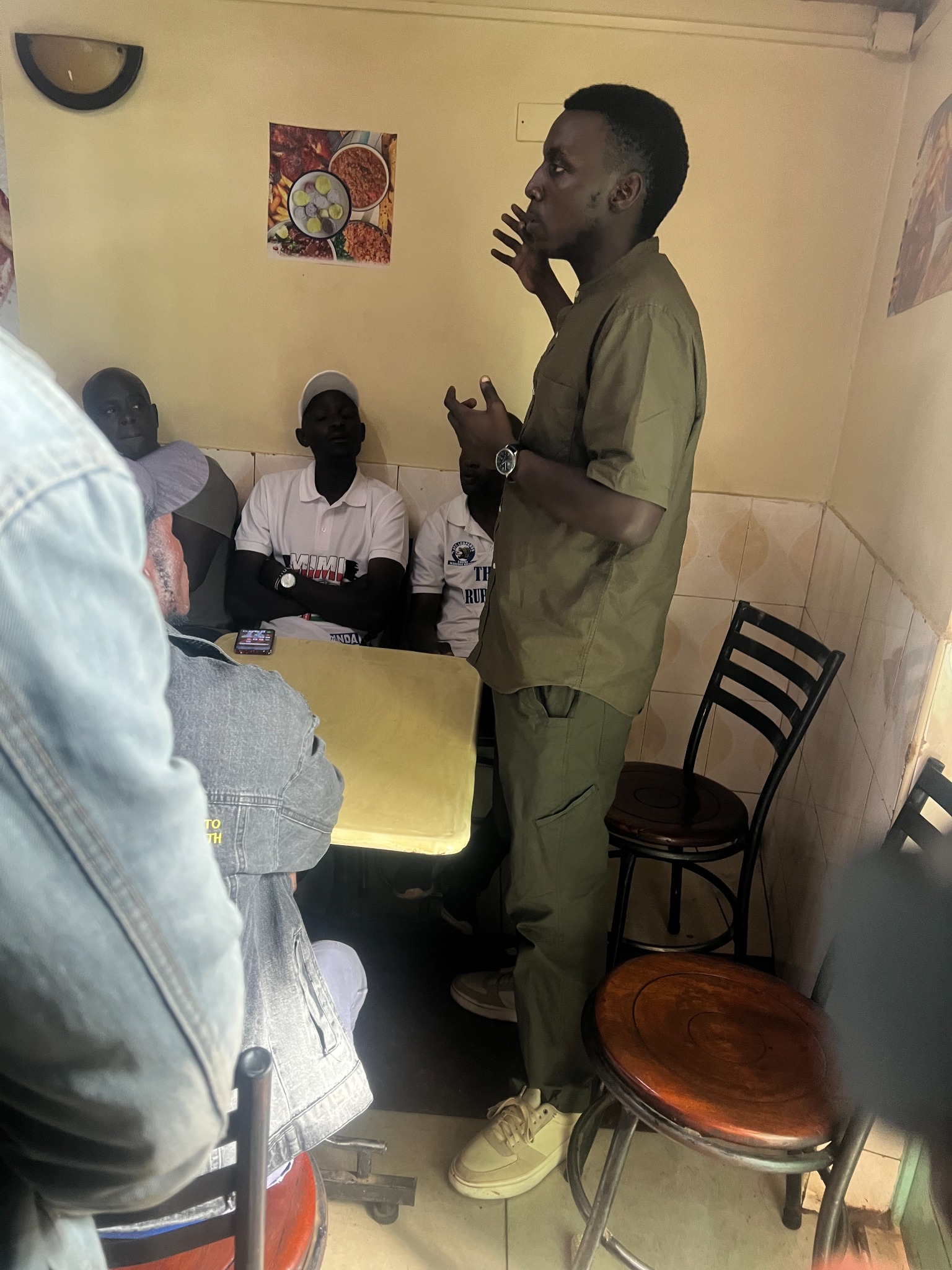 Munala speaking at a small community meeting