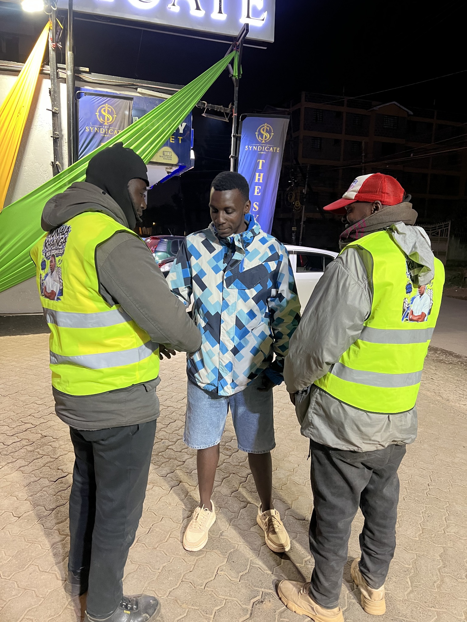 Munala and riders wearing reflective jackets at night